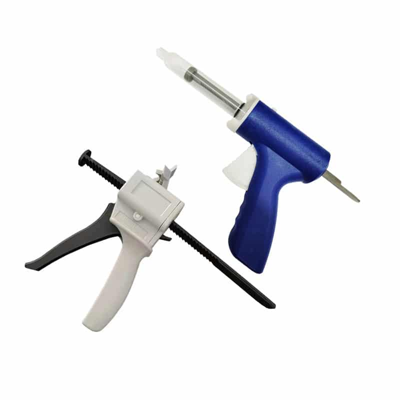An image showing two types of impression guns, one with a white and black handle and another with a blue handle, both designed for dispensing material, likely for impression procedures, isolated on a white background