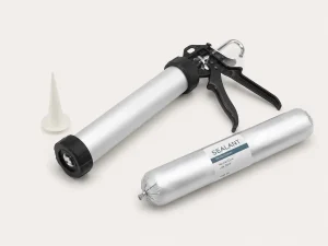Sausage caulking gun, nozzle, and 600 ml sausage pack prepared for loading sealant into the barrel.