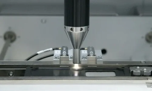 Automated dispensing nozzle applying industrial high-precision sealing material with extreme accuracy onto a metal component in a controlled manufacturing environment