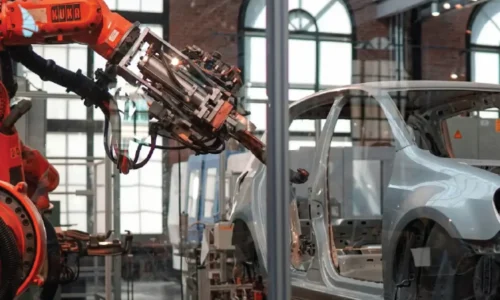 Industrial robot dispensing structural adhesive on vehicle body-in-white – btektech automated solutions